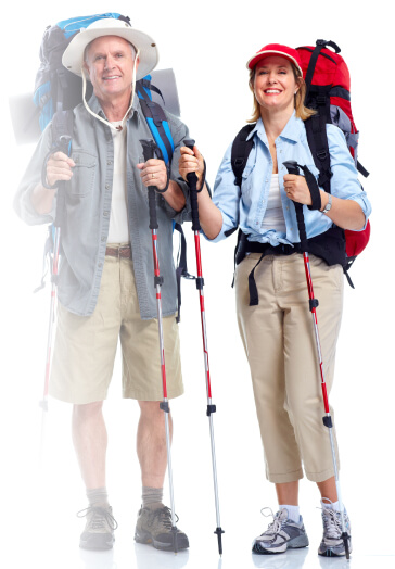 Elderly couple dressed in hiking gear smiling and ready for an outdoor hike