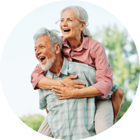 Elderly couple smiling outdoors